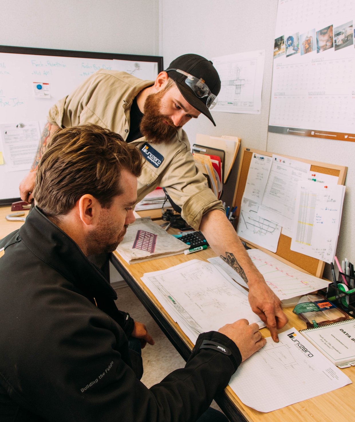 The Burkebro team reviewing steel building drawings on site